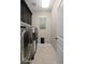 Convenient laundry room with washer, dryer, cabinets and a window for natural light at 12152 W Briles Rd, Peoria, AZ 85383
