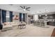 Open-concept living room and kitchen area with a plush sofa, island seating, and modern finishes at 12152 W Briles Rd, Peoria, AZ 85383