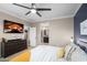 Beautiful main bedroom features a ceiling fan, TV, and en-suite bathroom at 12152 W Briles Rd, Peoria, AZ 85383
