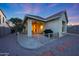 Outdoor patio at dusk with barbeque, chairs and neutral-toned stucco on a home surrounded by gravel and garden at 13295 N 153Rd Ln, Surprise, AZ 85379