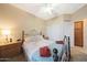 Cozy bedroom features a comfortable bed, ceiling fan, and convenient access to closet at 13295 N 153Rd Ln, Surprise, AZ 85379