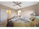 Cozy bedroom features a comfortable bed, ceiling fan, and en-suite bathroom access at 13295 N 153Rd Ln, Surprise, AZ 85379