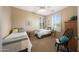 Cozy bedroom featuring two twin beds, plantation shutters, neutral decor, and ample natural light at 13295 N 153Rd Ln, Surprise, AZ 85379