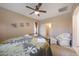 Bedroom featuring a comfortable bed, ceiling fan, and natural lighting at 13295 N 153Rd Ln, Surprise, AZ 85379