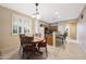 Bright dining area with tile flooring, shuttered windows, and adjacent kitchen at 13295 N 153Rd Ln, Surprise, AZ 85379