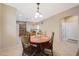 Dining area with wood table and chairs adjacent to the kitchen at 13295 N 153Rd Ln, Surprise, AZ 85379