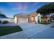 Beautiful single-story home with a well-maintained lawn, charming exterior details, and a two car garage at 13295 N 153Rd Ln, Surprise, AZ 85379