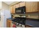 Well-lit kitchen with stainless steel appliances, gas cooktop, and wooden cabinets at 13295 N 153Rd Ln, Surprise, AZ 85379