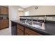 Kitchen sink with double basin, dark countertops and wooden cabinetry at 13295 N 153Rd Ln, Surprise, AZ 85379