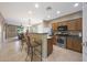Open kitchen with a breakfast bar, stainless steel appliances, and views into the living area at 13295 N 153Rd Ln, Surprise, AZ 85379