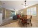 Open concept living room with ceiling fan, tiled floors, and slider door to backyard at 13295 N 153Rd Ln, Surprise, AZ 85379
