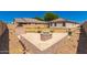 Spacious backyard featuring a tiled patio with a fire pit and outdoor grill at 1356 S Mosley Ct, Chandler, AZ 85286