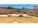 Backyard featuring a built-in BBQ area, fire pit, and rock landscaping at 1356 S Mosley Ct, Chandler, AZ 85286