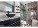 Modern bathroom with a marble walk-in shower, dark vanity, and contemporary vessel sink at 1356 S Mosley Ct, Chandler, AZ 85286