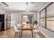Inviting dining room featuring modern lighting, stainless steel appliances, and a sliding glass door to a covered patio at 1356 S Mosley Ct, Chandler, AZ 85286