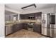 Modern kitchen with stainless steel appliances, tile floors, and granite countertops at 1356 S Mosley Ct, Chandler, AZ 85286
