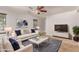 Bright living room with a ceiling fan, modern decor, plush seating, and a stylish rug creating a welcoming atmosphere at 1356 S Mosley Ct, Chandler, AZ 85286