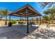 Shaded picnic area with tables and benches, next to a playground in a park setting at 1356 S Mosley Ct, Chandler, AZ 85286