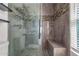 This luxurious walk-in shower features stone-look tile and an integrated bench at 1356 S Mosley Ct, Chandler, AZ 85286