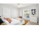 Cozy bedroom with white walls, sliding closet doors, ceiling fan, and natural light at 13620 N 80Th Pl, Scottsdale, AZ 85260