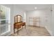 Walk-in closet space with antique vanity, natural lighting, and bamboo storage racks at 13620 N 80Th Pl, Scottsdale, AZ 85260