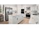 Modern kitchen featuring white cabinets, stainless steel appliances, and a marble-top island at 13620 N 80Th Pl, Scottsdale, AZ 85260