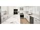 Well-lit kitchen showcasing marble countertops, stainless steel appliances, white cabinets and subway tile backsplash at 13620 N 80Th Pl, Scottsdale, AZ 85260