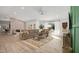 Spacious living room with a stone fireplace, a large sectional sofa, and backyard access at 13620 N 80Th Pl, Scottsdale, AZ 85260