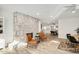 Open concept living room with a large stone fireplace and view of the kitchen and dining area at 13620 N 80Th Pl, Scottsdale, AZ 85260