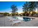 Inviting backyard pool lined with lounge chairs and mature landscaping, creating a private retreat at 13620 N 80Th Pl, Scottsdale, AZ 85260