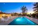 Backyard pool with lounge chairs, outdoor dining, and a built-in barbeque area with mountain views at 13620 N 80Th Pl, Scottsdale, AZ 85260