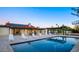 Inviting backyard pool with a covered bar, patio furniture, and solar panels on the house at 13620 N 80Th Pl, Scottsdale, AZ 85260