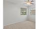 This bedroom features neutral carpet, a ceiling fan and windows with views at 1453 E South Fork Dr, Phoenix, AZ 85048