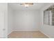 Empty bedroom with neutral paint, tile floor, ceiling fan, and natural light at 1453 E South Fork Dr, Phoenix, AZ 85048