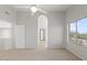 Spacious bedroom featuring neutral paint, carpet, ceiling fan, and large window at 1453 E South Fork Dr, Phoenix, AZ 85048