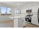 Bright kitchen boasts white cabinets, stainless steel appliances, and center island, blending style and functionality at 1453 E South Fork Dr, Phoenix, AZ 85048