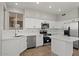 Bright kitchen boasts white cabinets, stainless steel appliances, and center island, blending style and functionality at 1453 E South Fork Dr, Phoenix, AZ 85048