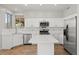 Bright kitchen boasts white cabinets, stainless steel appliances, and center island, blending style and functionality at 1453 E South Fork Dr, Phoenix, AZ 85048