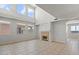 Spacious living room with fireplace, tile flooring, and an abundance of natural light at 1453 E South Fork Dr, Phoenix, AZ 85048