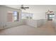 Cozy carpeted loft area with multiple windows and ceiling fans, providing ample natural light at 1453 E South Fork Dr, Phoenix, AZ 85048
