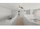 Bright and airy carpeted loft area with multiple ceiling fans and staircase access at 1453 E South Fork Dr, Phoenix, AZ 85048