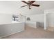Upstairs carpeted loft featuring a ceiling fan, railing and lots of space for entertaining at 1453 E South Fork Dr, Phoenix, AZ 85048