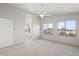 Spacious main bedroom with natural light, ceiling fan, and access to an ensuite bathroom at 1453 E South Fork Dr, Phoenix, AZ 85048