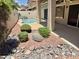 Beautiful backyard featuring a swimming pool, a covered patio, and attractive rock landscaping at 16242 S 12Th Pl, Phoenix, AZ 85048