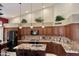 Modern kitchen featuring granite countertops, dark wood cabinets, mosaic tile backsplash, and stainless appliances at 16242 S 12Th Pl, Phoenix, AZ 85048