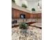 Kitchen with granite counters, wood cabinets and eat-in table featuring a succulent arrangement at 16242 S 12Th Pl, Phoenix, AZ 85048