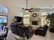 Bright living room with fireplace, shutters, ceiling fan, leather seating and views to the outside at 16242 S 12Th Pl, Phoenix, AZ 85048