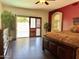Spacious main bedroom with hardwood floors, ensuite bathroom, access to backyard, and dark wood furnishings at 16242 S 12Th Pl, Phoenix, AZ 85048