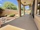 A covered patio featuring stone pillars, a ceiling fan, and views of the pool and rock landscaping at 16242 S 12Th Pl, Phoenix, AZ 85048