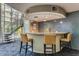 Modern bar area with counter seating, mosaic tile backdrop, and a nearby staircase at 1701 E Colter St # 491, Phoenix, AZ 85016